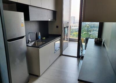 Modern kitchen with stainless steel appliances and large window