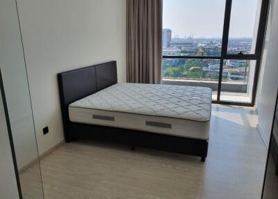 Modern bedroom with large window and city view