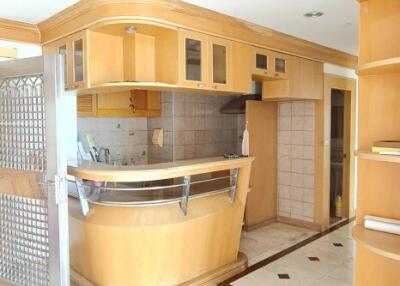 Modern kitchen with wooden cabinets and bar area