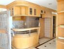 Modern kitchen with wooden cabinets and bar area