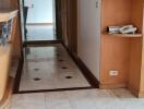 Bright hallway with marble flooring and built-in shelves