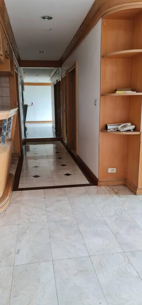 Bright hallway with marble flooring and built-in shelves