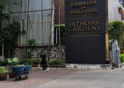 Exterior view of the Sathorn Gardens Condominium and the Embassy of Malaysia sign