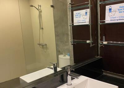 Modern bathroom with sink, mirror, and shower area