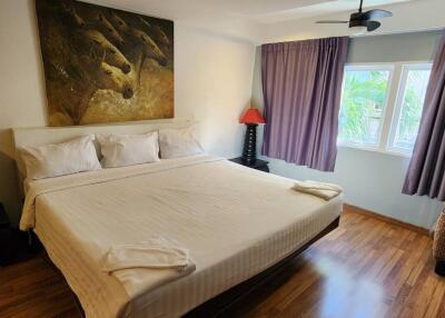 Modern bedroom with king-sized bed and large window