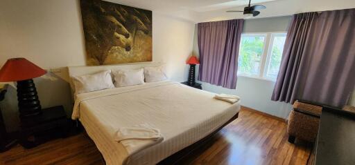 Modern bedroom with king-sized bed and large window