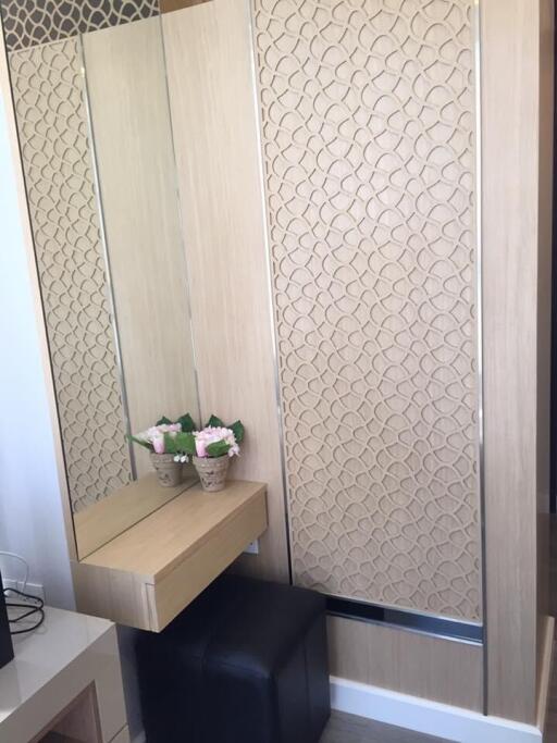 Bedroom with built-in vanity and textured wardrobe