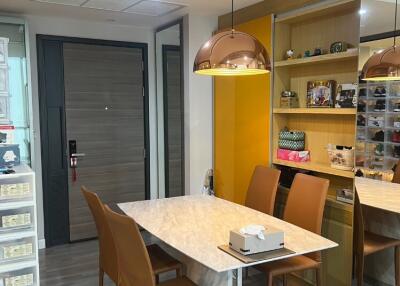 Modern dining area with marble table and brown chairs