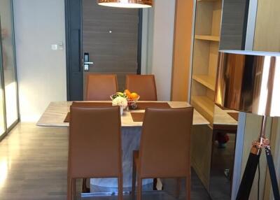 Modern dining room with a table set for four and contemporary lighting