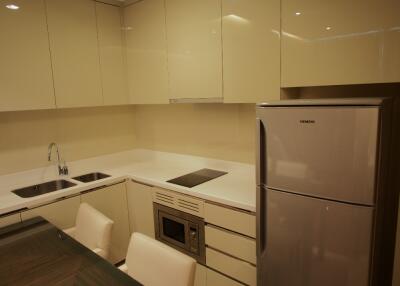 Modern kitchen with cream cabinets and stainless steel appliances