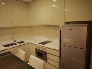 Modern kitchen with cream cabinets and stainless steel appliances