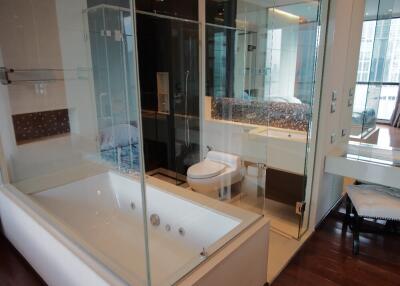 Modern bathroom with glass shower enclosure and bathtub