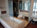 Modern bathroom with glass shower enclosure and bathtub