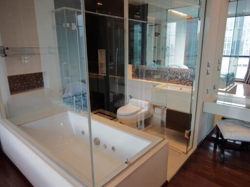 Modern bathroom with glass shower enclosure and bathtub