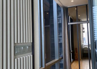 Modern hallway with wooden floor and glass door