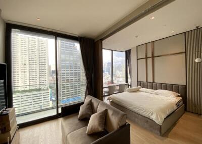 Spacious modern bedroom with large windows and city view