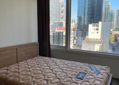 Bedroom with large window and city view