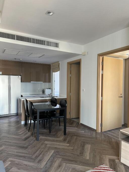 Modern kitchen and dining area with wooden flooring