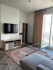 Modern living room with TV and glass coffee table