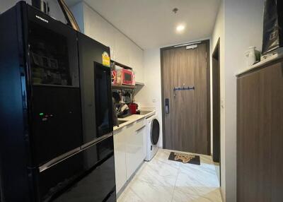 Modern kitchen with black refrigerator and white cabinetry