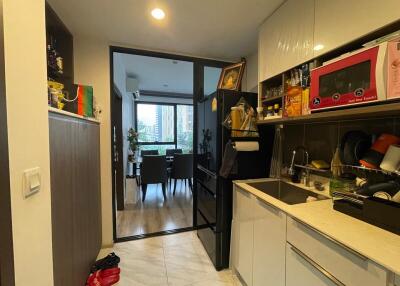 Modern kitchen with black and white cabinetry, view of dining area