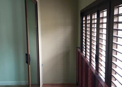 Balcony with sliding glass door and wooden shutters