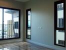 Modern bedroom with polished wooden floor and large windows labeled Bedroom 1