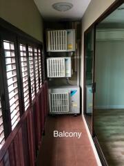 Balcony area with multiple air conditioning units and sliding glass door