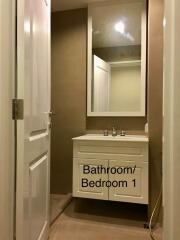 Bathroom featuring a modern vanity with large mirror