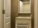 Bathroom featuring a modern vanity with large mirror