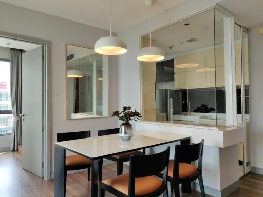 Modern dining area with table and chairs, adjacent to the kitchen