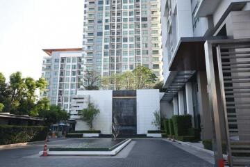 Modern high-rise residential building with water feature