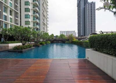 Outdoor swimming pool area with surrounding buildings