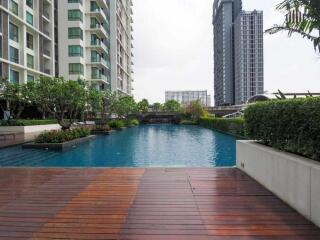 Outdoor swimming pool area with surrounding buildings