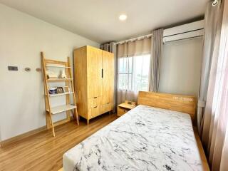 Modern bedroom with wooden furniture and air conditioning