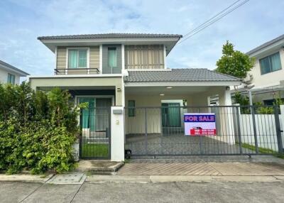 Front view of a house with for sale sign