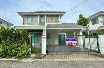 Front view of a house with for sale sign