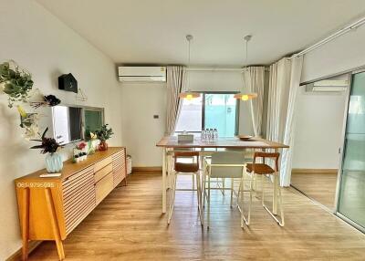 Modern dining area with wooden flooring and stylish furniture