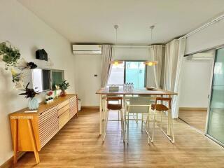 Modern dining area with wooden flooring and stylish furniture