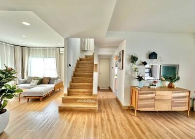 Spacious living room with wooden flooring and staircase