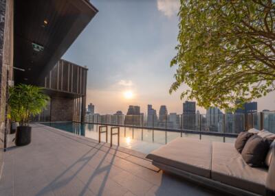 Luxurious outdoor terrace with pool and city skyline view