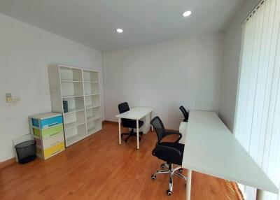 Spacious home office with multiple desks and chairs