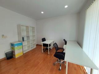 Spacious home office with multiple desks and chairs