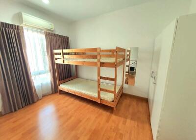 Bedroom with bunk beds, wooden floor, and wardrobe