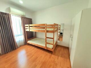 Bedroom with bunk beds, wooden floor, and wardrobe