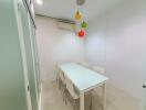 Modern dining area with a glass table and colorful pendant lights