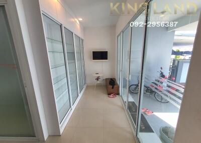 Bright hallway with glass doors and built-in shelves