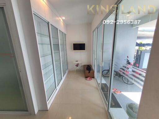 Bright hallway with glass doors and built-in shelves