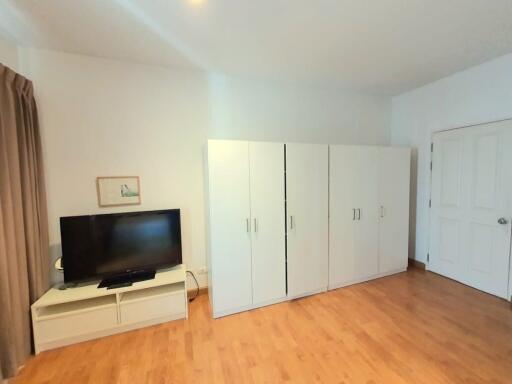 Bedroom with wardrobe and TV