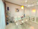 Modern dining room with glass table and six white chairs